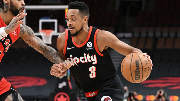 Portland Trail Blazers guard CJ McCollum (3) dribbles the ball past Toronto Raptors guard Gary Trent Jr.
